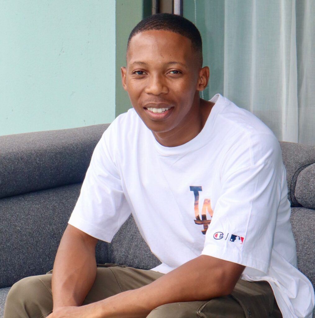 Black man sitting and smiling