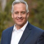 Old man wearing a suit smiling