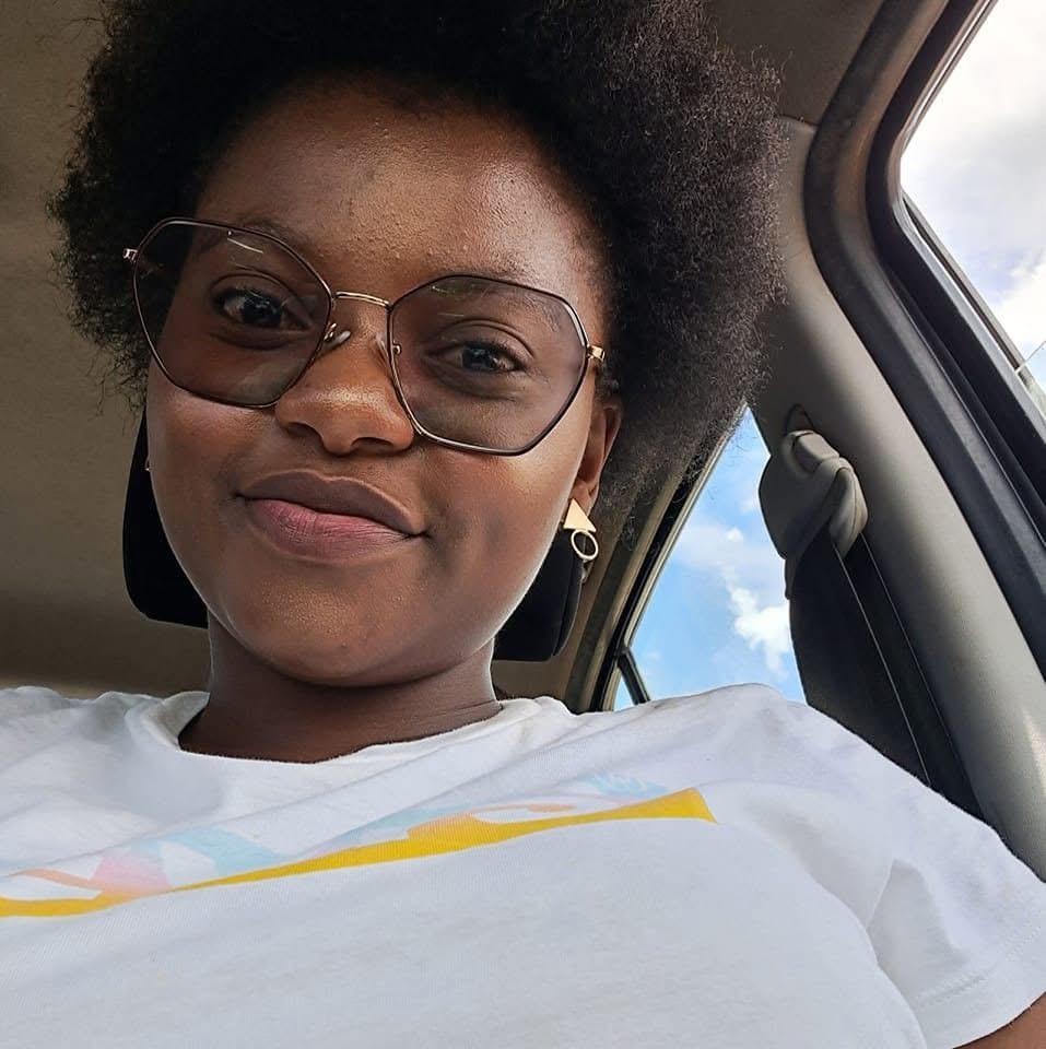 Black woman with glasses smiling