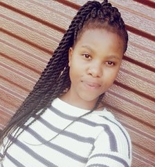 Black woman standing in front of a garage door